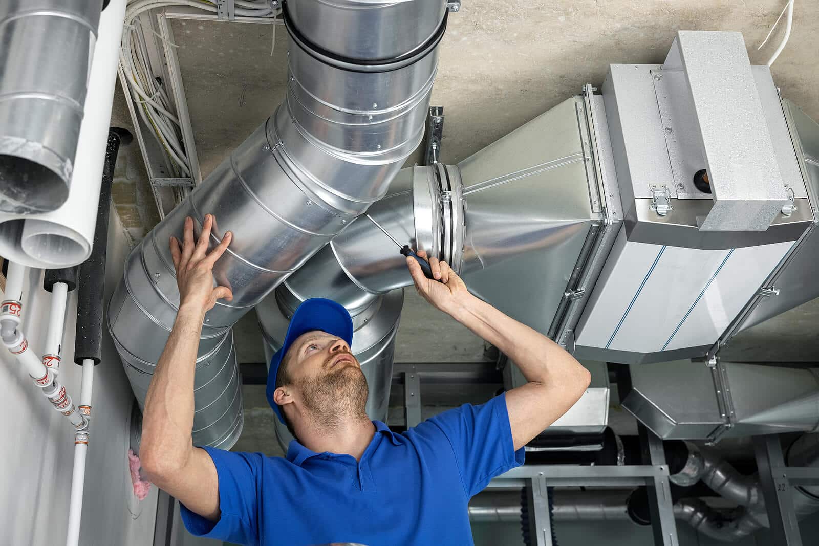 HVAC technician inspecting and repairing air ducts in Cerritos