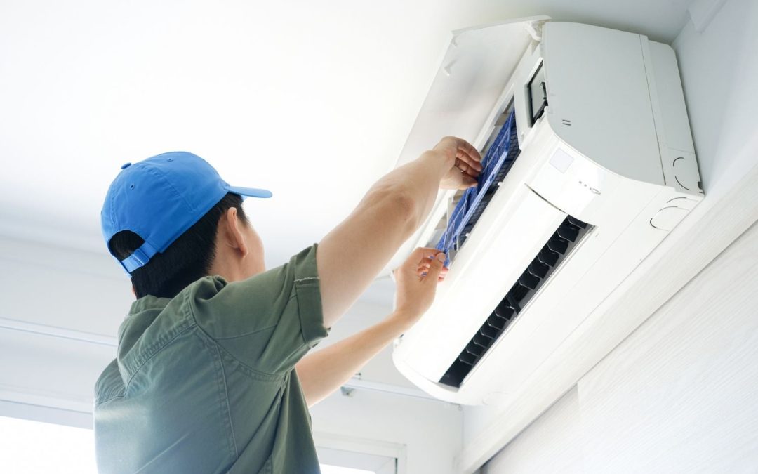 HVAC technician servicing a ductless mini split in Cerritos