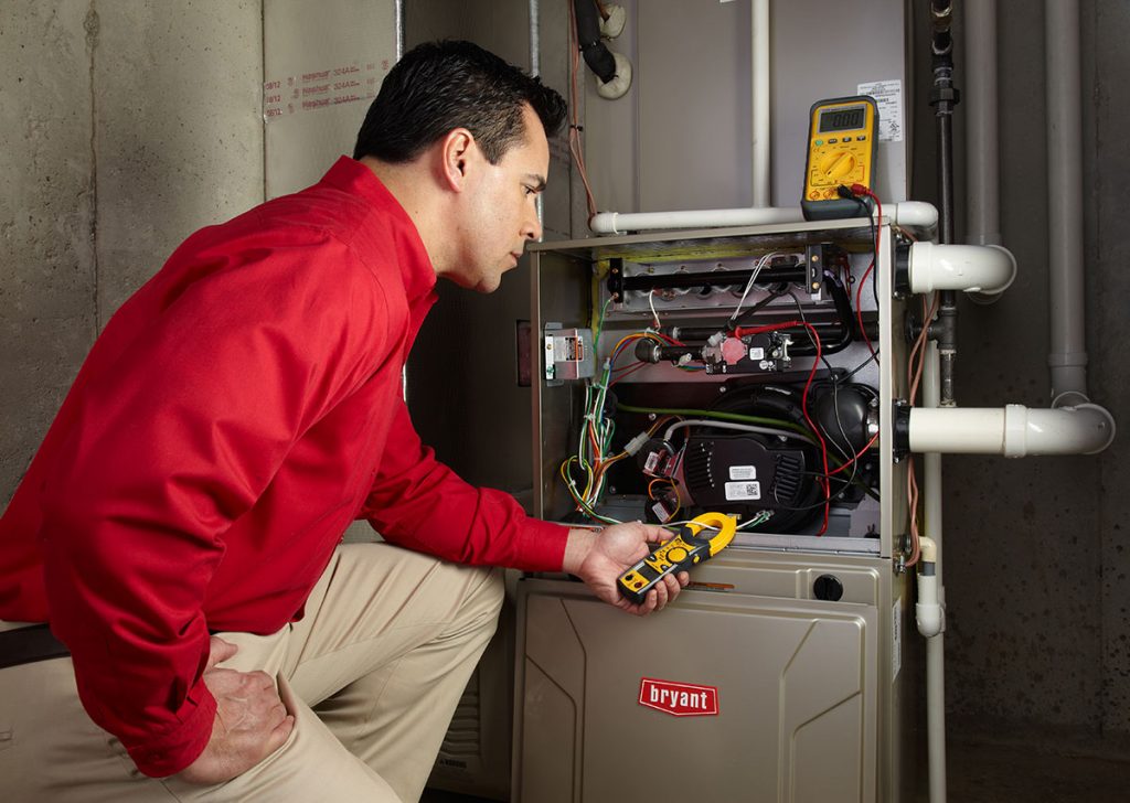 Heating technician diagnosing a furnace repair in Cerritos