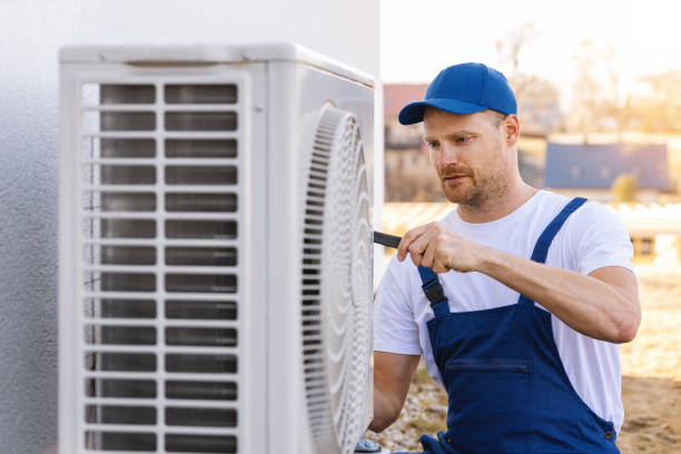 HVAC technician servicing an outdoor air conditioner in Cerritos