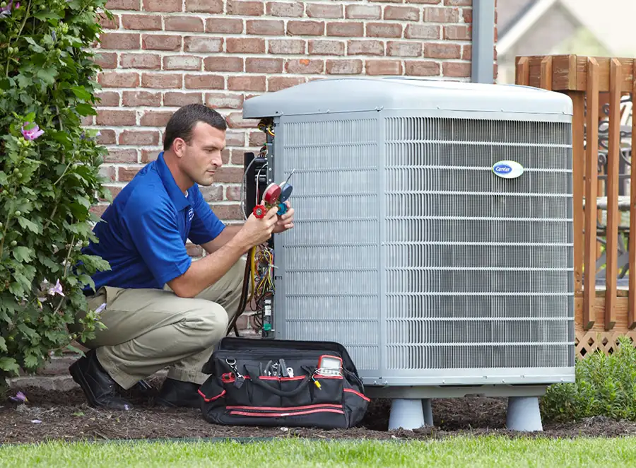 HVAC technician inspecting an outdoor AC unit in Cerritos